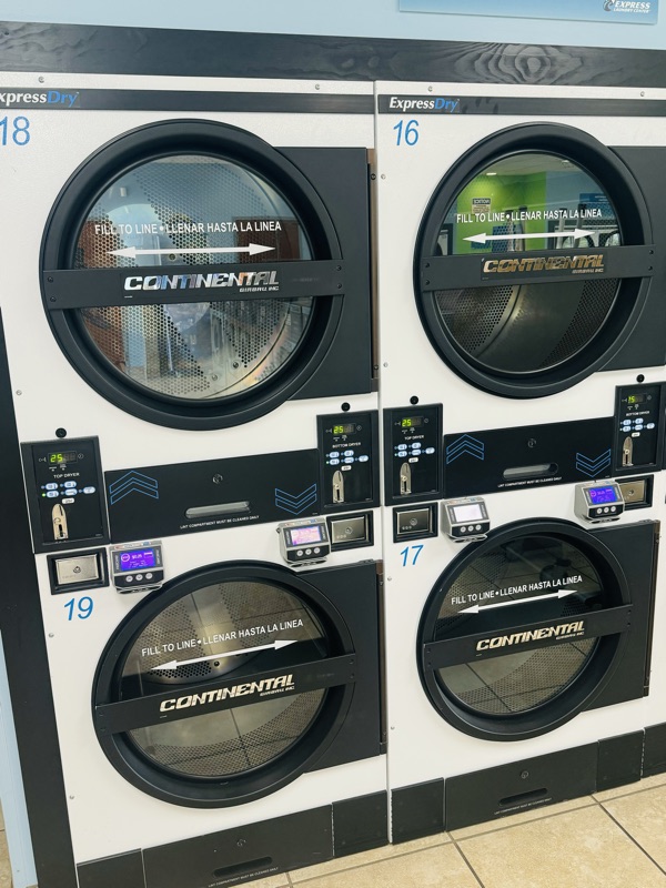 Close-up of stacked dryer doors with their controls