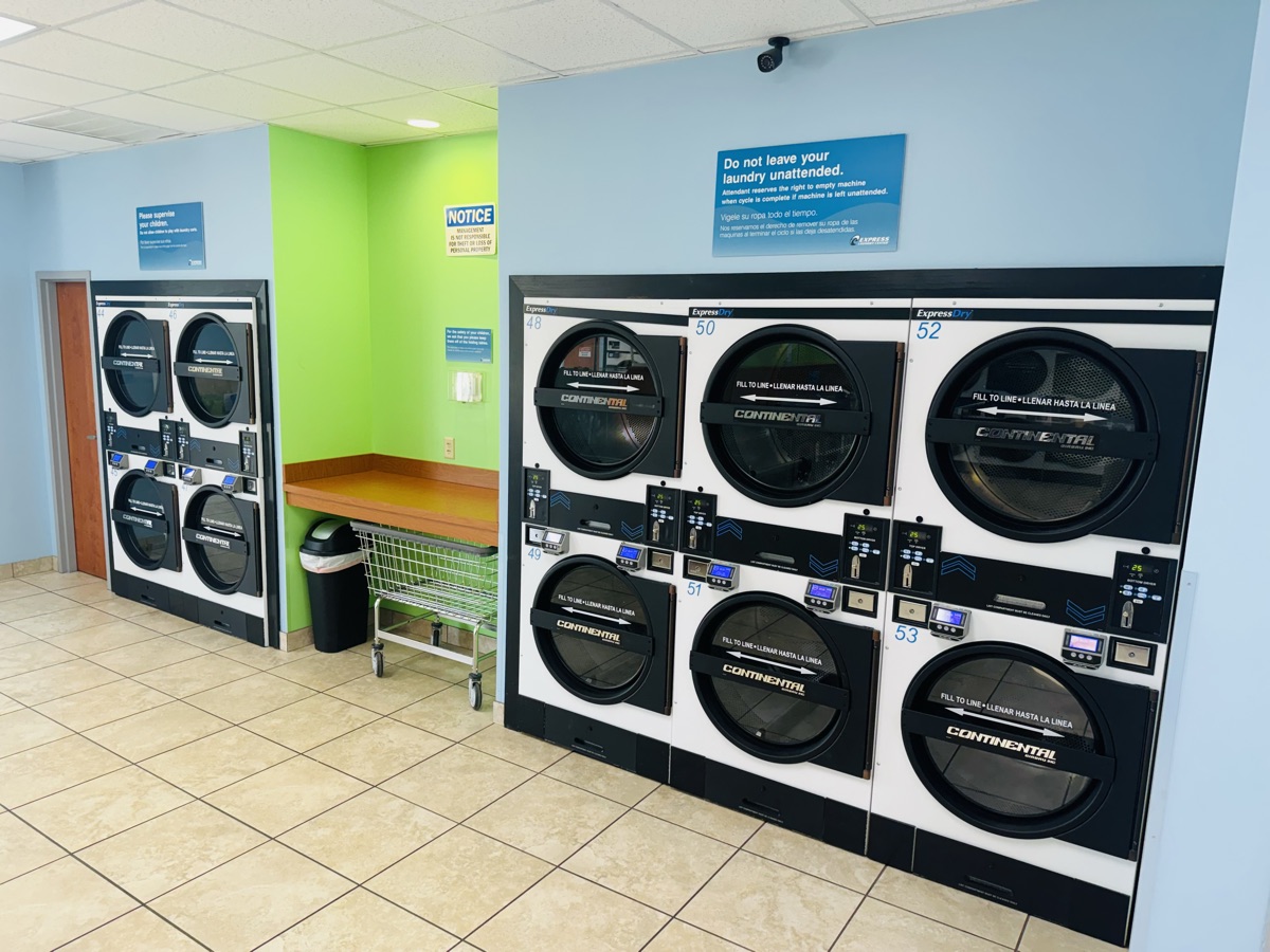 Dryers and folding tables at Express Laundry Center in Knoxville, open every day including Sunday