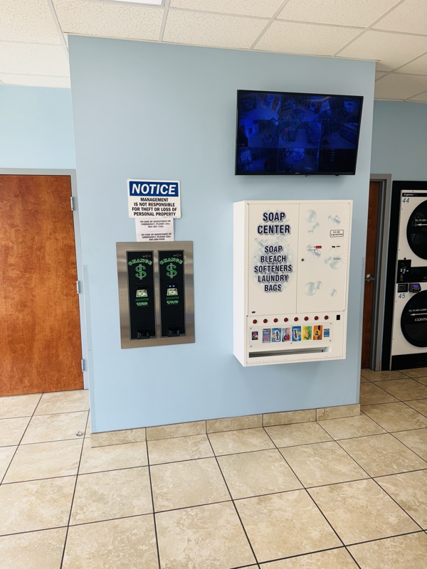 Soap and detergent vending, two change machines for quarters, and the security camera monitor