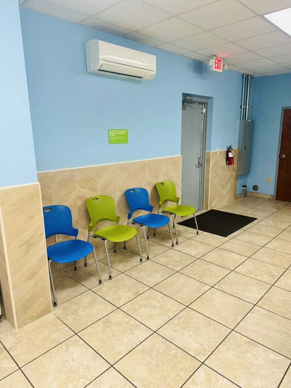 Waiting area chairs against the wall inside the laundromat