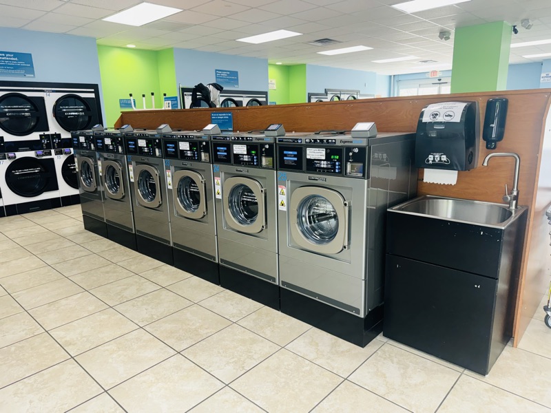 A row of high-efficiency front-load washers on the floor at Express Laundry Center in Knoxville